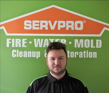 Photo of a man in front of a Servpro logo