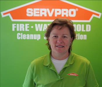 Woman in front of green SERVPRO Logo