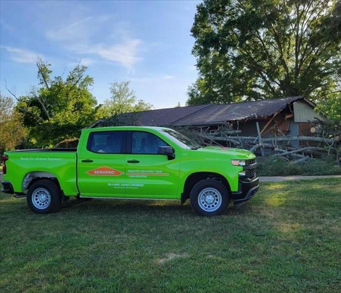 servpro truck in front of damaged home