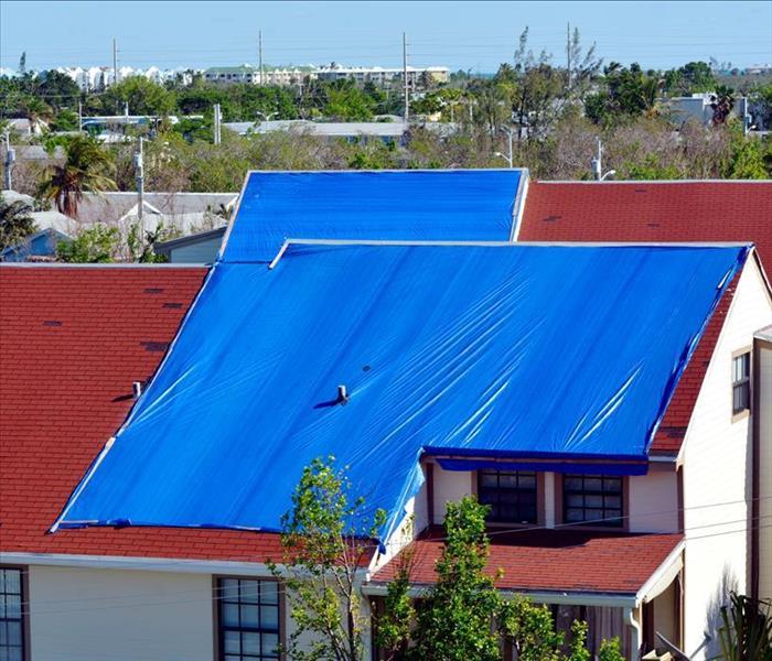 Blue tarp on roof of a house